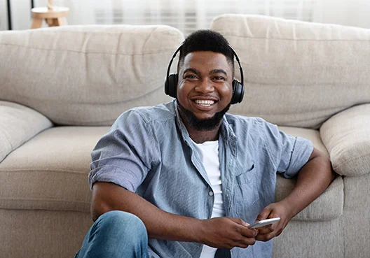 Man sitting on the floor with headphones on