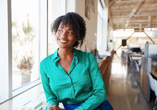 lady leaning against a window sill looking out