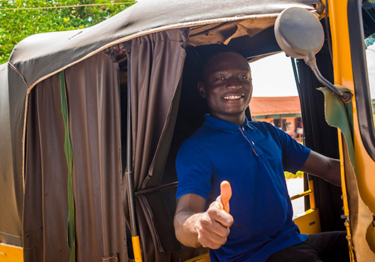 a man facing the camera with a thumbs up