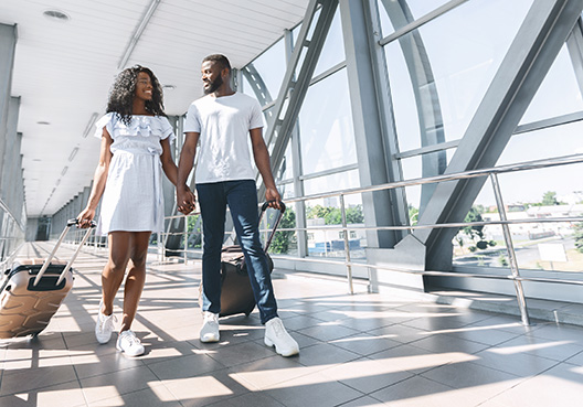 couple walking hand in hand at the airport