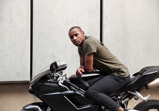man sitting on motorcycle looking at the camera