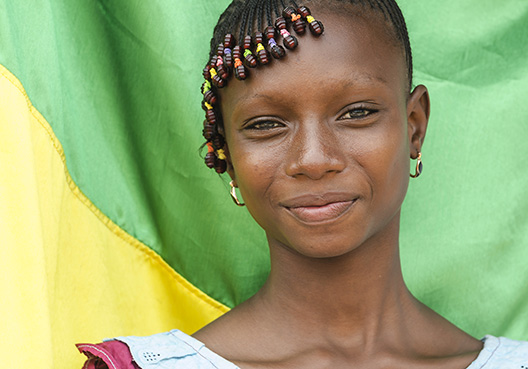 Girl standing in front of a flag
