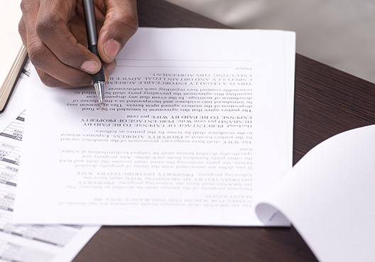 man signing a document